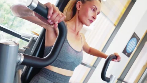 Woman Exercising on Pec Deck Machine in Gym 스톡 동영상 323621295