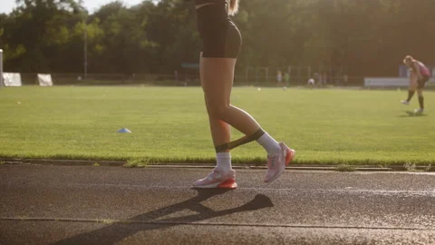 A woman is exercising at the stadium. The athlete is doing exercises with a Stock Footage 280404053