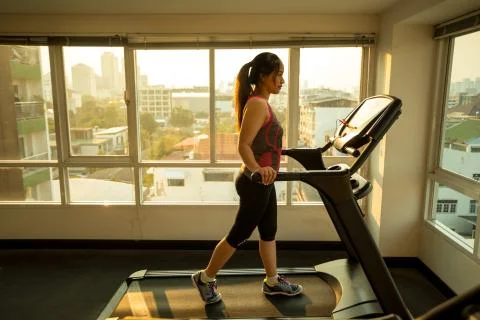 Woman exercising on a treadmill Stock Photos