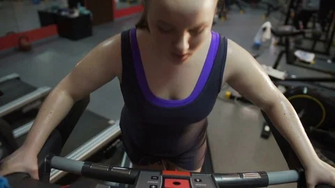 Woman exercising on treadmill wrong way, breathing heavily, having chest pain Stock Footage 73468364
