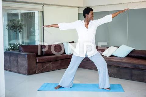 Woman Exercising On Yoga Mat