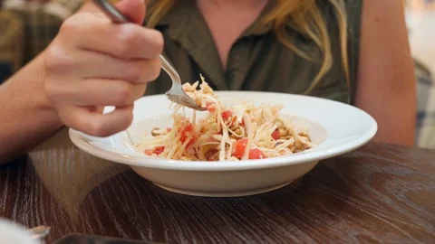 Woman exhausted by diet, eating cabbage salad in a cafe. 4k, slow motion. copy Stock Footage