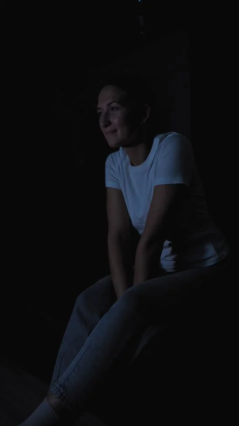 Woman experiencing intense emotion while watching television alone Stock Footage 295847883