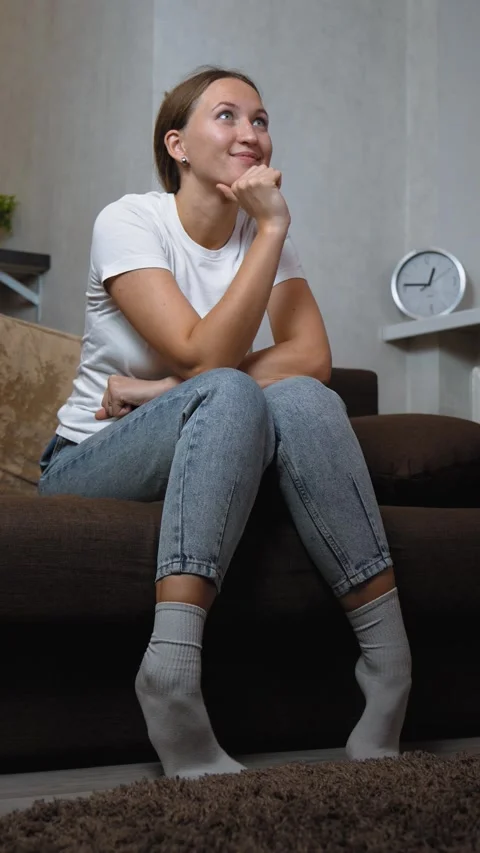 Woman experiencing intense emotion while watching television alone Stock Footage 295849127