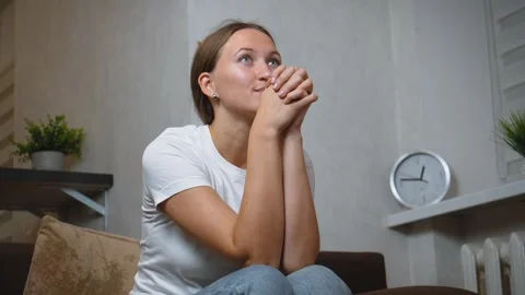 Woman experiencing intense emotion while watching television alone Stock Footage 295849180