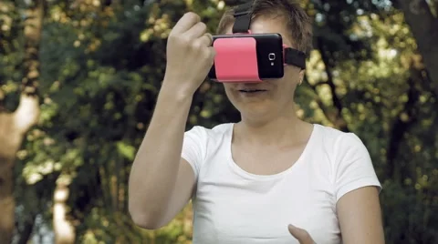 Woman explores virtual reality using VR glasses Stock-Footage 66725355