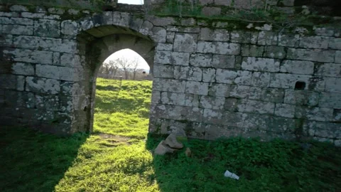 Woman exploring ancient medieval stone ruins Видео 336482937