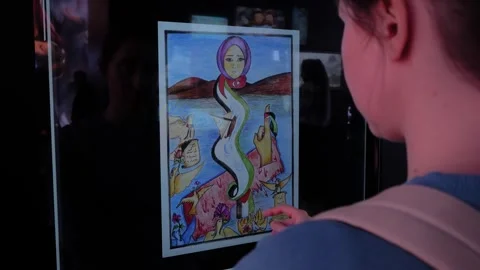 Woman exploring drawings at interactive screen exhibition in Istanbul Stock Footage 344955800
