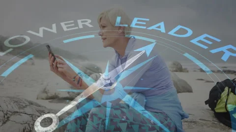 Woman exploring navigation app on smartphone at beach showing compass and POWER Stock Footage 308026023