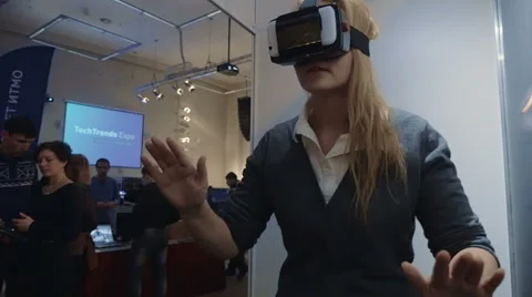 Woman Exploring Virtual Reality at Tech Ehxibition Stock Footage 52439606