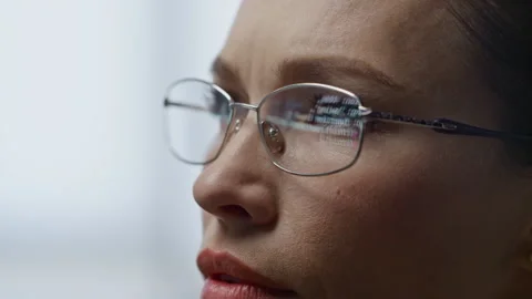 Woman eyeglasses reflecting code closeup. Focused developer operator talking Stock Footage 242953289