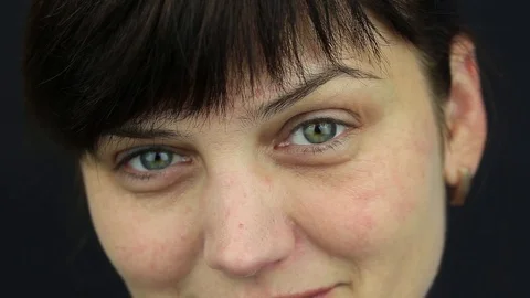Woman eyes , she stares into camera, portrait woman, macro, indoors Stock Footage
