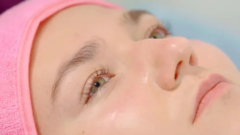 Woman face during procedure of correcting and coloring of eyebrows, master is 库存影片 96999965