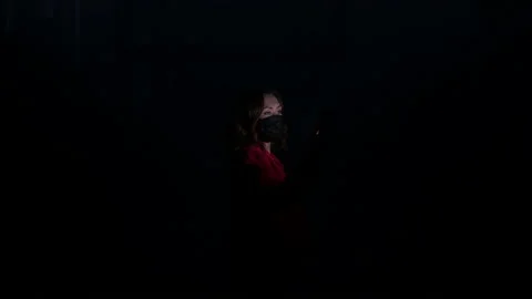 Woman in a face mask using mobile phone hacking abstract big data center 動画素材 145435501