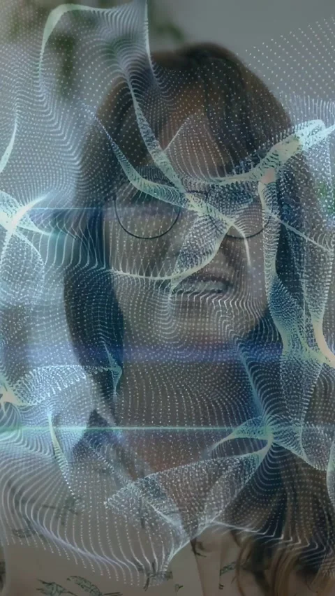 Woman facing camera, activating AR mesh over glasses and revealing smile during 库存影片 333006435