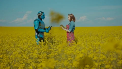 Woman farm engineer interacting with android cybernetic assistant giving Stock Footage 133291373