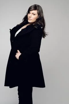 Woman, fashion and portrait of plus size model posing in winter clothing against Stock Photos