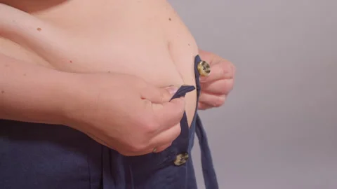Woman with fat belly tries button up sma... | Stock Video | Pond5