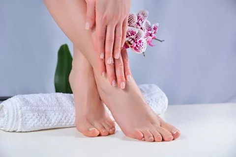 Woman feet and hands with natural polish color manicure and pedicure Stock Photos