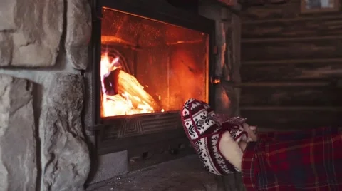 Woman Feet in Comfy red Slippers by Burning Christmas Fireplace. 4K STABILIZED Stock Footage