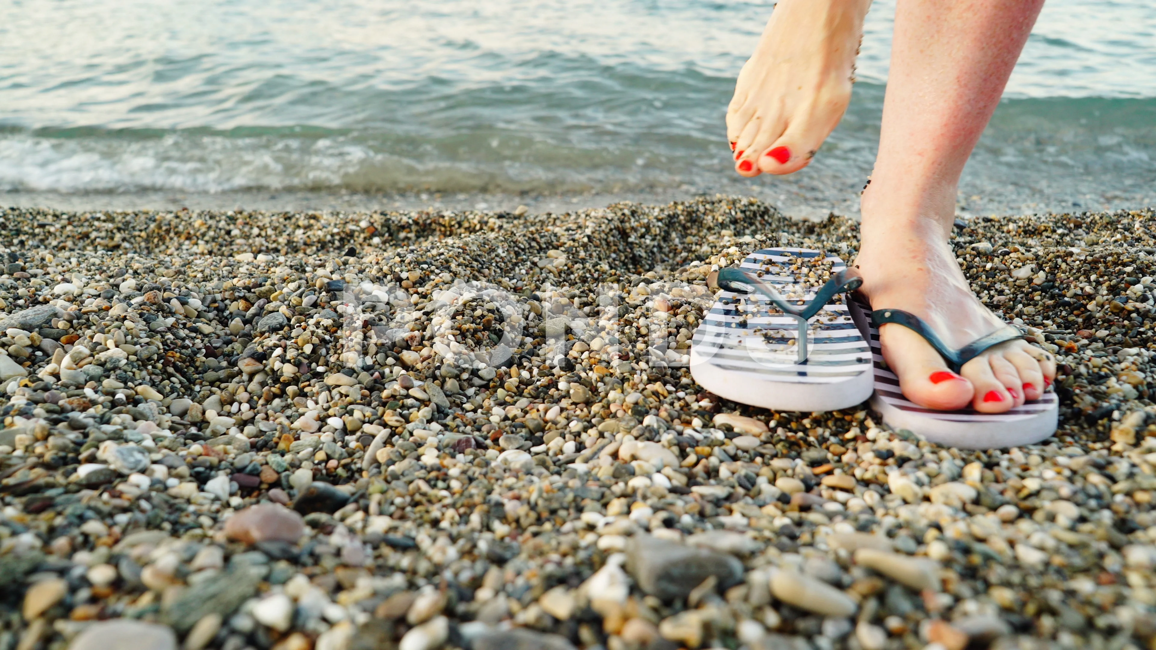 Woman feet with flip flops on beach shor, Stock Video