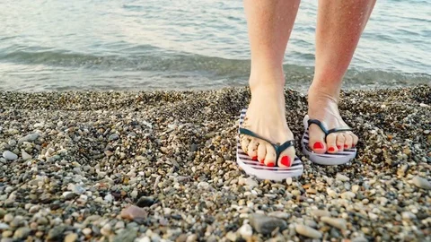 Woman feet with flip flops on beach shor, Stock Video