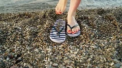 Woman feet with flip flops on beach shor, Stock Video