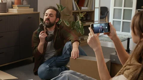Woman Filming Husband Assembling Flatpack Drawer on Smartphone Stock Footage 330509257