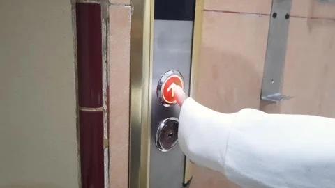 Woman finger presses the elevator up button upper high level floor. Stock Footage 333104557