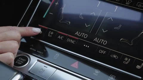 Woman finger pressing touchscreen button to activate seat heating in car Stock Footage 339334763