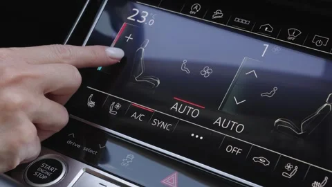 Woman finger pressing touchscreen button to decrease car climate control Stock Footage 339334833