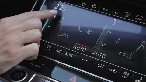 Woman finger pressing touchscreen button to increase car climate control Stock Footage 339334836