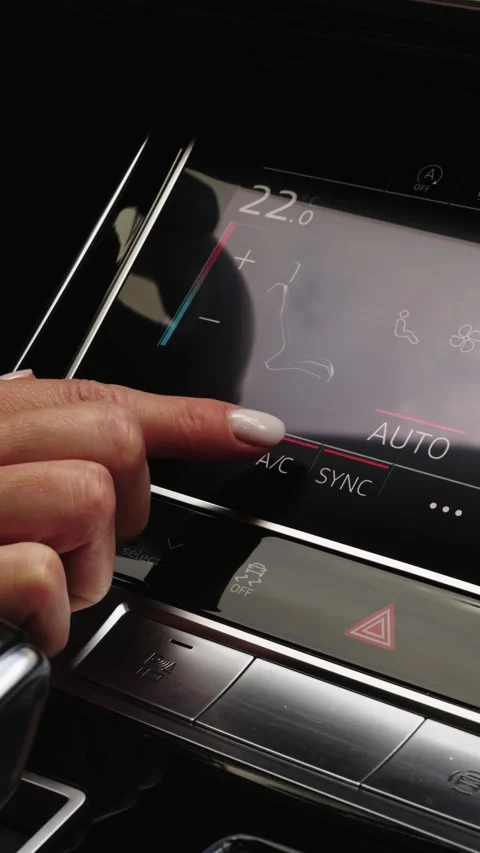 Woman finger pressing touchscreen button to turn on car air conditioning Stock Footage 339334896