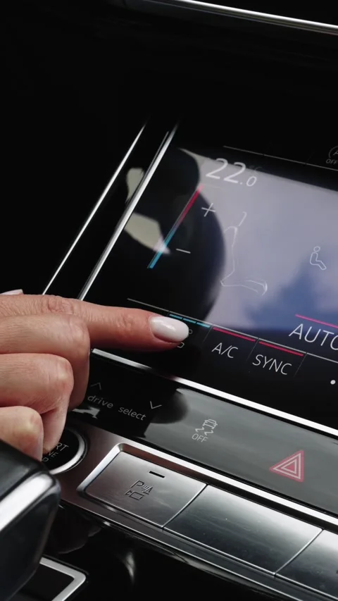 Woman finger pressing touchscreen button to activate seat ventilation in car Stock Footage 339334929