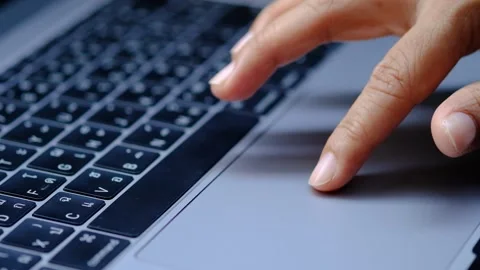 Woman with a finger on the screen using a computer in the office. Stock Footage 306960869