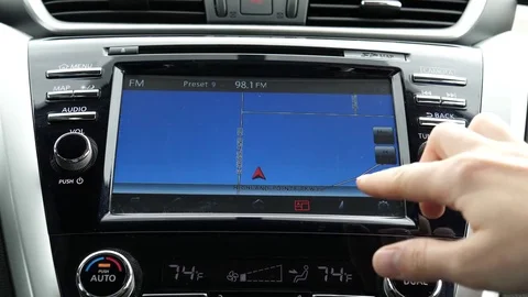 Woman fingers using a touch screen navigation system GPS in Nissan murano car Stock Footage 80775653