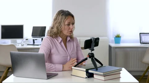 Woman Finishes Explaining Something While Recording Herself Stock Footage 135025509