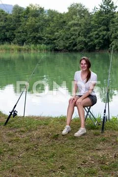 Woman fishing at a lake Stock Photos