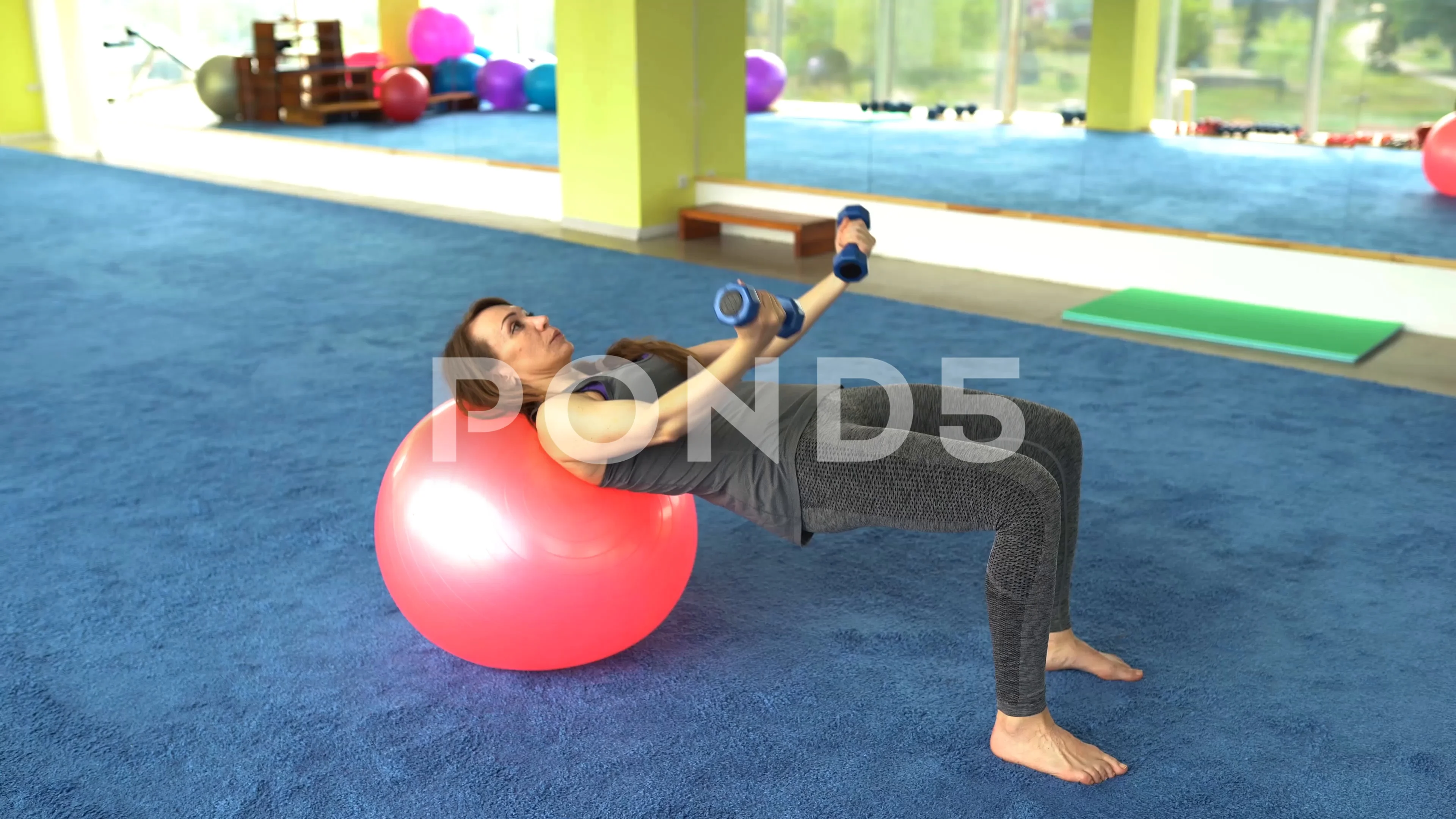 Woman fitness. mature woman doing exercise with ball in gym . healthy  lifestyle