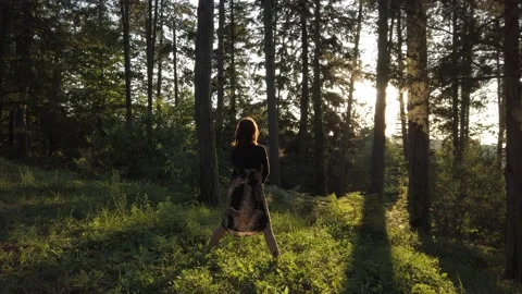 Woman in flash light opens his arms in pine forest. Connection with nature. Stock Footage 137589953