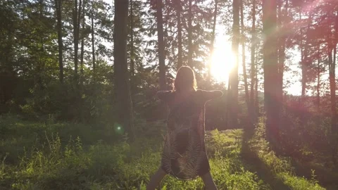 Woman in flash light opens his arms in pine forest. Connection with nature. Stock Footage 137590159