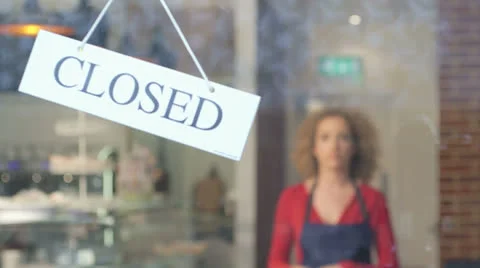 Woman flipping over closed sign Stock Footage