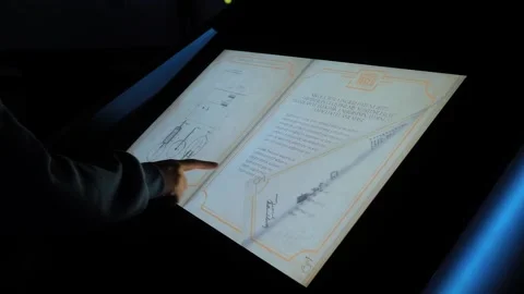 Woman flips through interactive multimedia book in Digital Museum Video stock 339027015