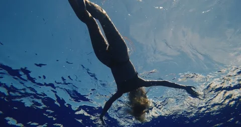 Woman floating on back in ocean Stock Footage 315080644