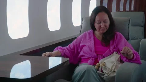 Woman flying first class on a private jet Stock Footage 332392229
