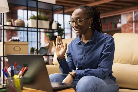 Woman focused on a virtual workshop to learn new skills from her apartment Stock Photos