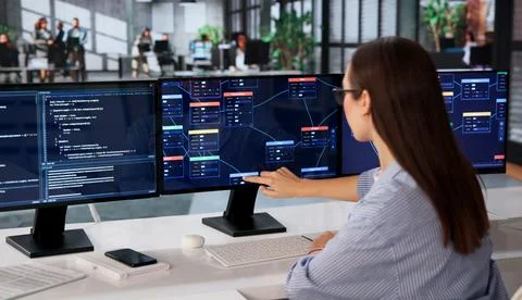 Woman Focused On Visual Programming Using Node-based No Code Software. Stock-Fotos