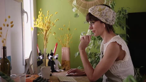 Woman focused working on computer at home, remote work productivity and Stock Footage 334097705