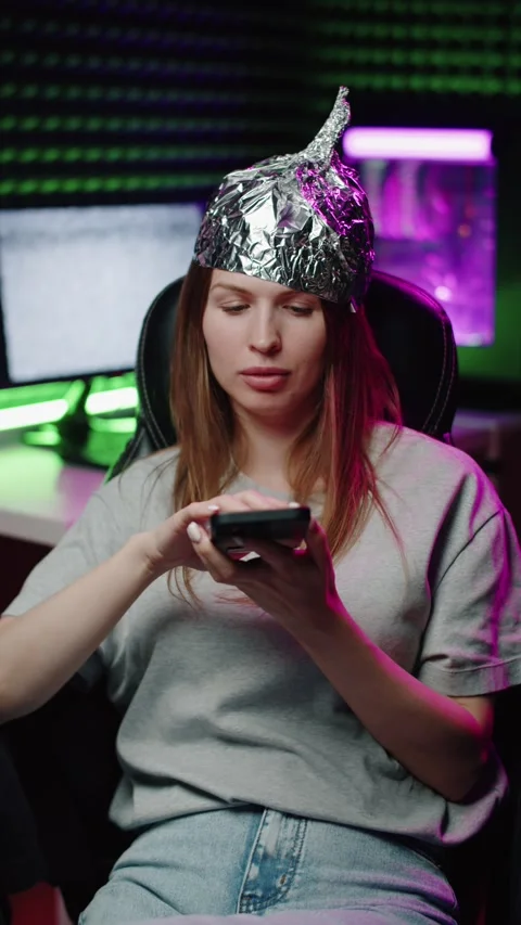 Woman in Foil Hat Using Her Smartphone Video stock 322897528