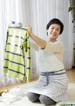 Woman folding laundry Stock Photos